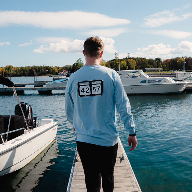 42-57 long-sleeve tshirt worn by a man on a dock