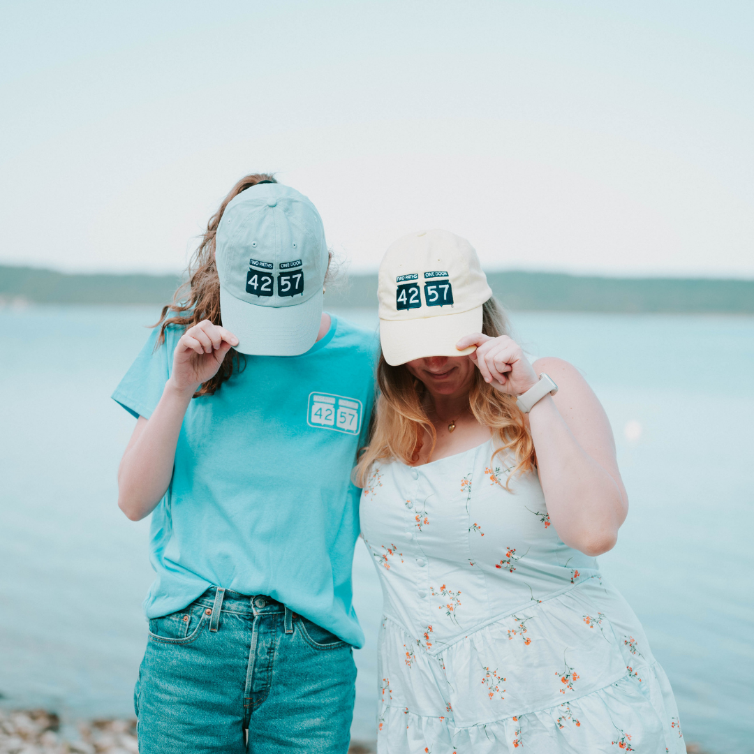 Models wearing 42-57 Classic Cap in blue and yellow in Door County, Wisconsin