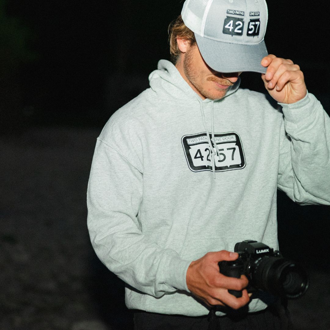 Model wearing 42-57 Trucker Cap in gray in Door County, Wisconsin