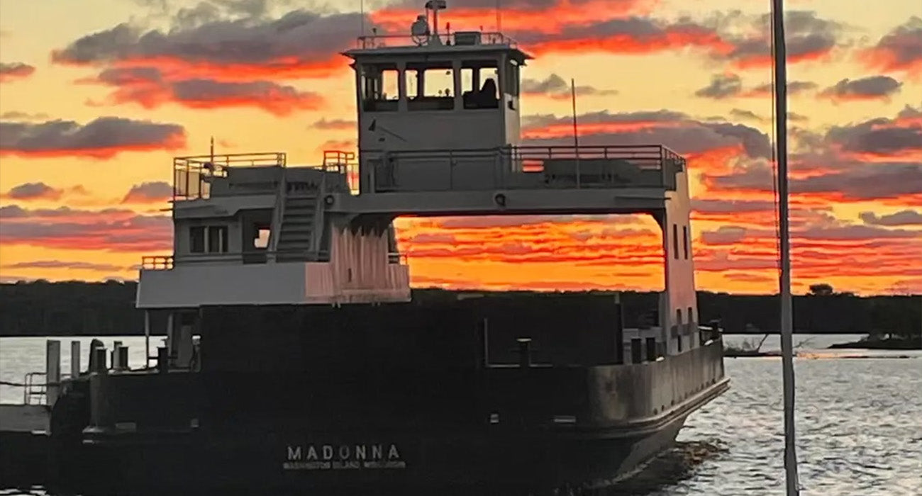 a ferry boat at sunset
